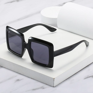 Modern oversized square sunglasses with thick black frames and dark lenses for women