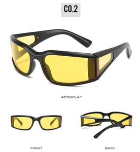Detail view of sports sunglasses featuring matte black frames and yellow side-wrap lenses