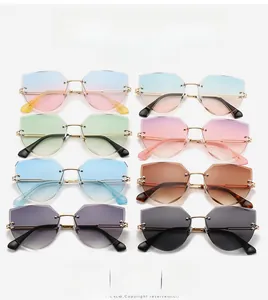 Detail view of eight multi-colored rimless geometric sunglasses with gold metal frames