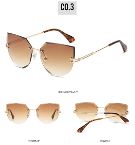 Detail view of rimless cat-eye sunglasses with brown gradient geometric lenses and gold arms