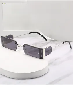 Detail of square silver metal sunglasses with semi-rimless frame and grey lenses