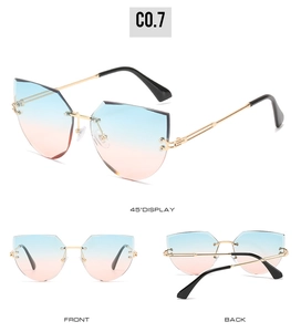 Detail view of rimless cat-eye sunglasses with blue-pink gradient lenses and gold metal frames