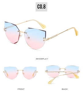 Detail view of rimless cat-eye sunglasses with blue-pink gradient lenses and gold metal frames