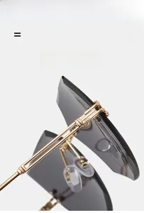 Detail of gold metal temples and adjustable nose pads on rimless cat eye sunglasses