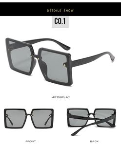 Detail view of large square sunglasses with black frames and gold rivet accents