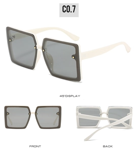 Detailed views of square oversized sunglasses with ivory frames and gradient brown accents
