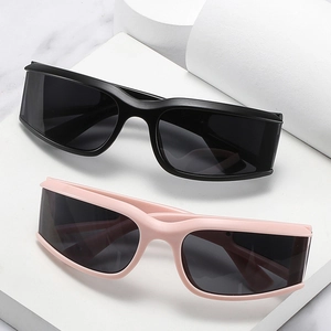 Modern oversized wrap cycling sunglasses in black and pink on white marble base