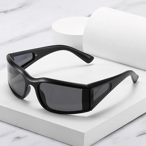 Sporty matte black wraparound sunglasses with gray lenses on a white minimalist stand