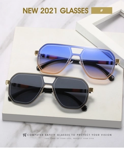 Detail of oversized metal sunglasses with gradient lenses and striped temple tips