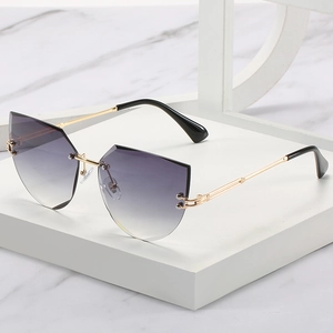 Frameless cat-eye sunglasses with purple gradient lenses and gold metal temples