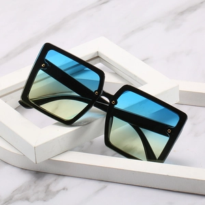 Oversized square sunglasses with gradient lenses and golden rivet studs on black frame
