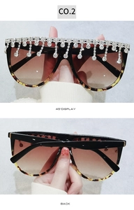 Detail einer übergroßen Sonnenbrille mit Strass-Fransen und Schildpatt-Rahmenstruktur
