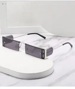 Detail view of silver metal punk sunglasses with side lenses on white geometric slabs