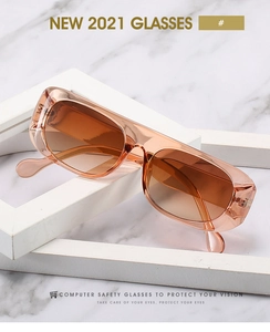 Détail de lunettes de soleil vintage ambrées avec verres marron dégradés de mode