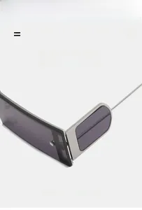 Detail of square punk sunglasses featuring flexible metal hinges and grey tinted lenses