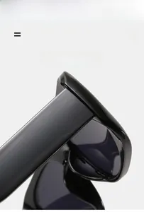 Détail de la monture de lunettes de soleil en PC noir brillant montrant le matériau élastique