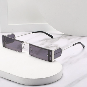 Rectangular punk sunglasses with silver metal frame and side lens on marble background
