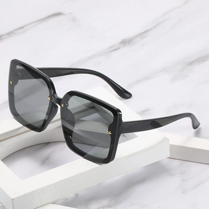 Lunettes de soleil carrées noires classiques avec accents dorés et verres gris