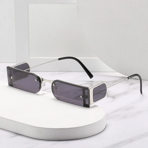 Retro rectangle rimless sunglasses with silver metal frame and gradient lenses on marble stand