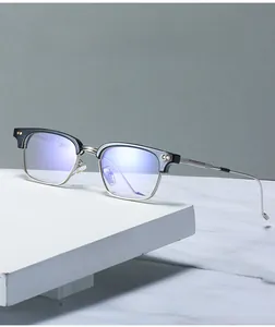 Close-up of semi-rimless anti blue light glasses on a white marble surface