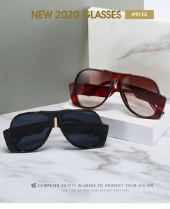 Detail view of retro oversized sunglasses with wide temples on white marble base