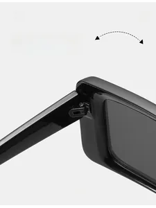 Detail of durable metal hinges on classic thick-framed black square sunglasses