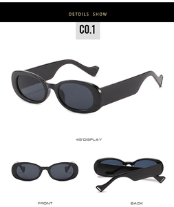 Détail de lunettes de soleil rondes avec branches ondulées larges et monture noire