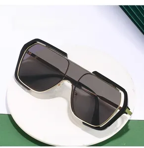 Macro shot of stylish square sunglasses with gold metal trim and tinted lenses
