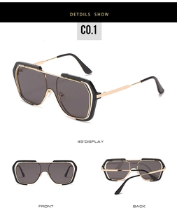 Detail view of oversized square sunglasses featuring black and gold double frame design