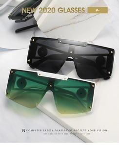 Detailed macro view of trendy oversized sunglasses with golden rivet accents on frames