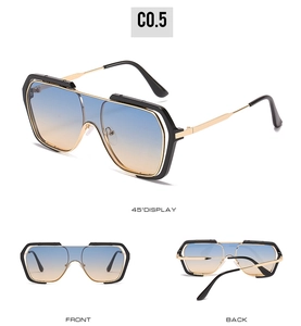 Detail view of large square sunglasses with blue-orange gradient lenses and black-gold frames