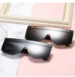 Close-up of flat top shield sunglasses in classic black and leopard tortoise finish