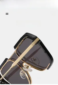 Close-up of lightweight oversized square sunglasses with gold metal bridge and soft nose pads
