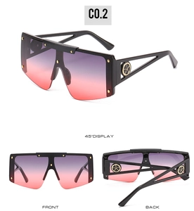 Detailed view of oversized gradient sunglasses with gold rivets and industrial hollow temples