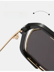 Detail of durable gold metal hinge on black oversized square frame sunglasses