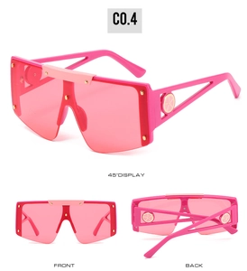 Three-view display of oversized rose pink wrap-around sunglasses with gold rivet accents