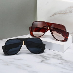 Classic oversized aviator sunglasses with gold metal bridge on marble display