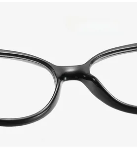 Close-up of comfortable integrated nose pads on black glossy eyeglass frames