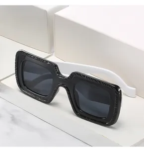 Détail des lunettes de soleil carrées avec texture spirale et monture bicolore noir blanc