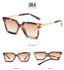 Detail of tortoiseshell square sunglasses with gold woven metal temples and gradient lenses