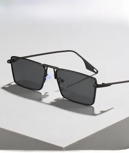 Close-up of matte black metal square frame sunglasses with soft nose pads on gray stand