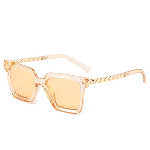 Oversized square orange sunglasses with vintage gold V-pattern metal temples on white base