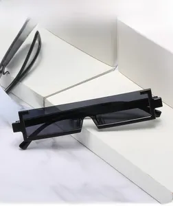 Detail view of pixel style sunglasses with stepped rectangle frame on marble stand