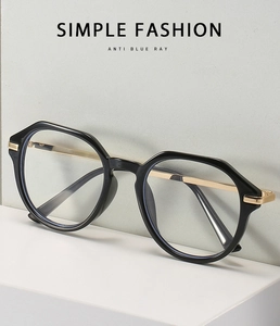 Detail of polygonal glasses frame with gold metal temples and anti blue ray lens