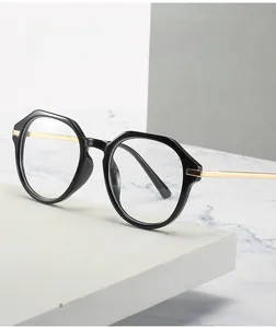 Detail of anti-blue light glasses with black polygonal frame and gold metal temples