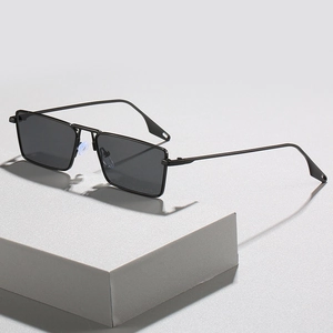 Retro square metal frame sunglasses with dark gray lenses on minimalist gray stand