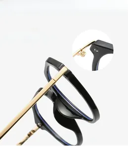 Macro detail of the durable metal hinge and golden temples on black square glasses frame