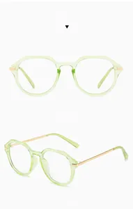 Detailed views of green transparent round glasses with stylish golden metal temples