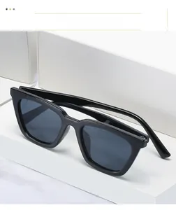 Side view of retro cat eye sunglasses with thick black frames on minimalist blocks