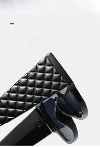 Detail view of black cat-eye sunglasses featuring embossed quilted pattern on wide temples